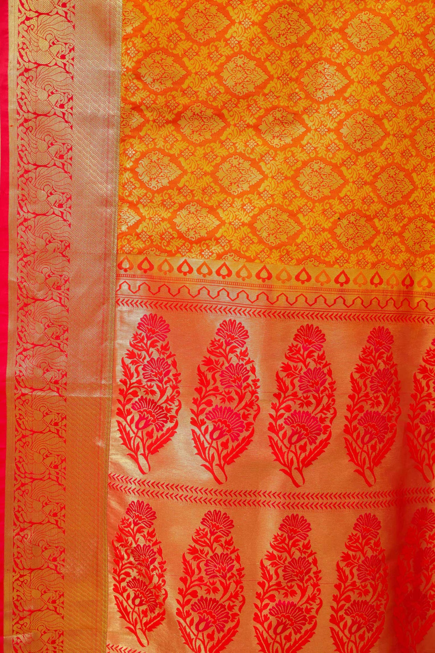 Close-up of Banarasi saree design with gold zari detailing and rich silk texture – pure Banarasi craftsmanship