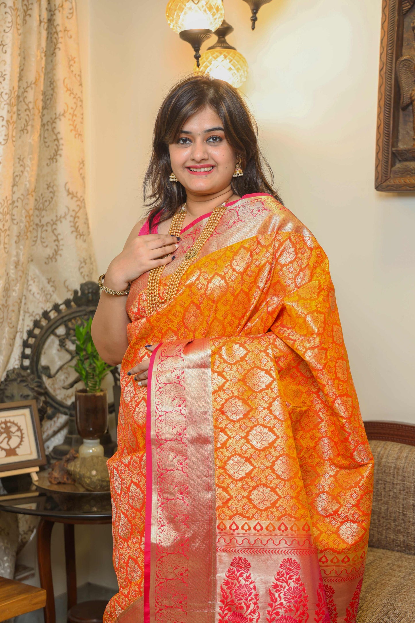 Bright orange Banarasi silk saree with pink border – pure handloom Banarasi saree design for festivals