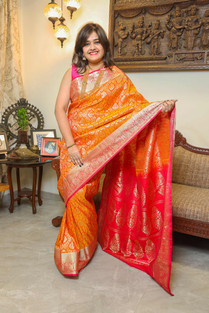 Pure Banarasi silk saree in vibrant orange with contrasting pink border