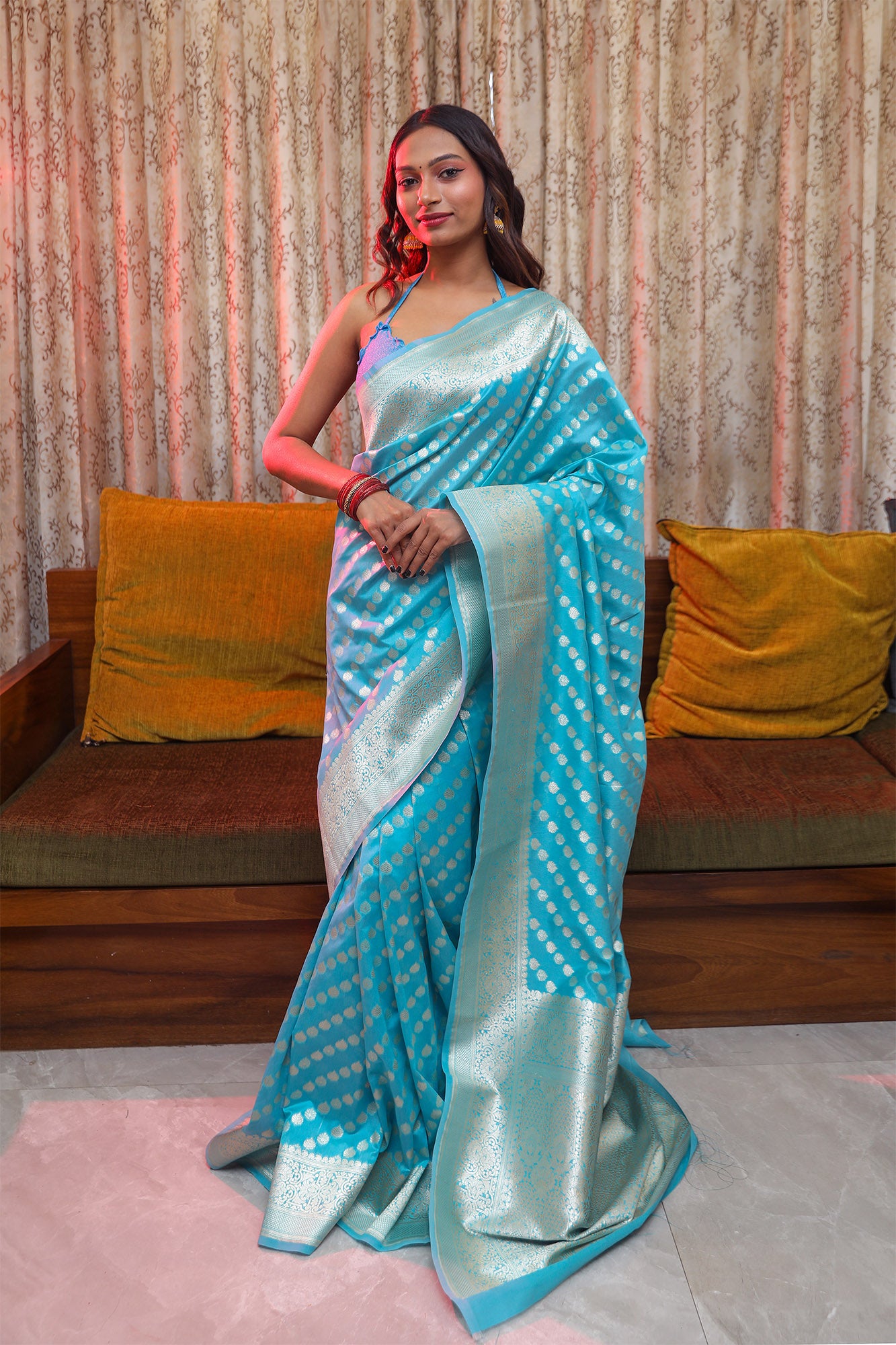 Model wearing light blue Katan silk Banarasi saree with all-over zari motifs and ornate palla – front look