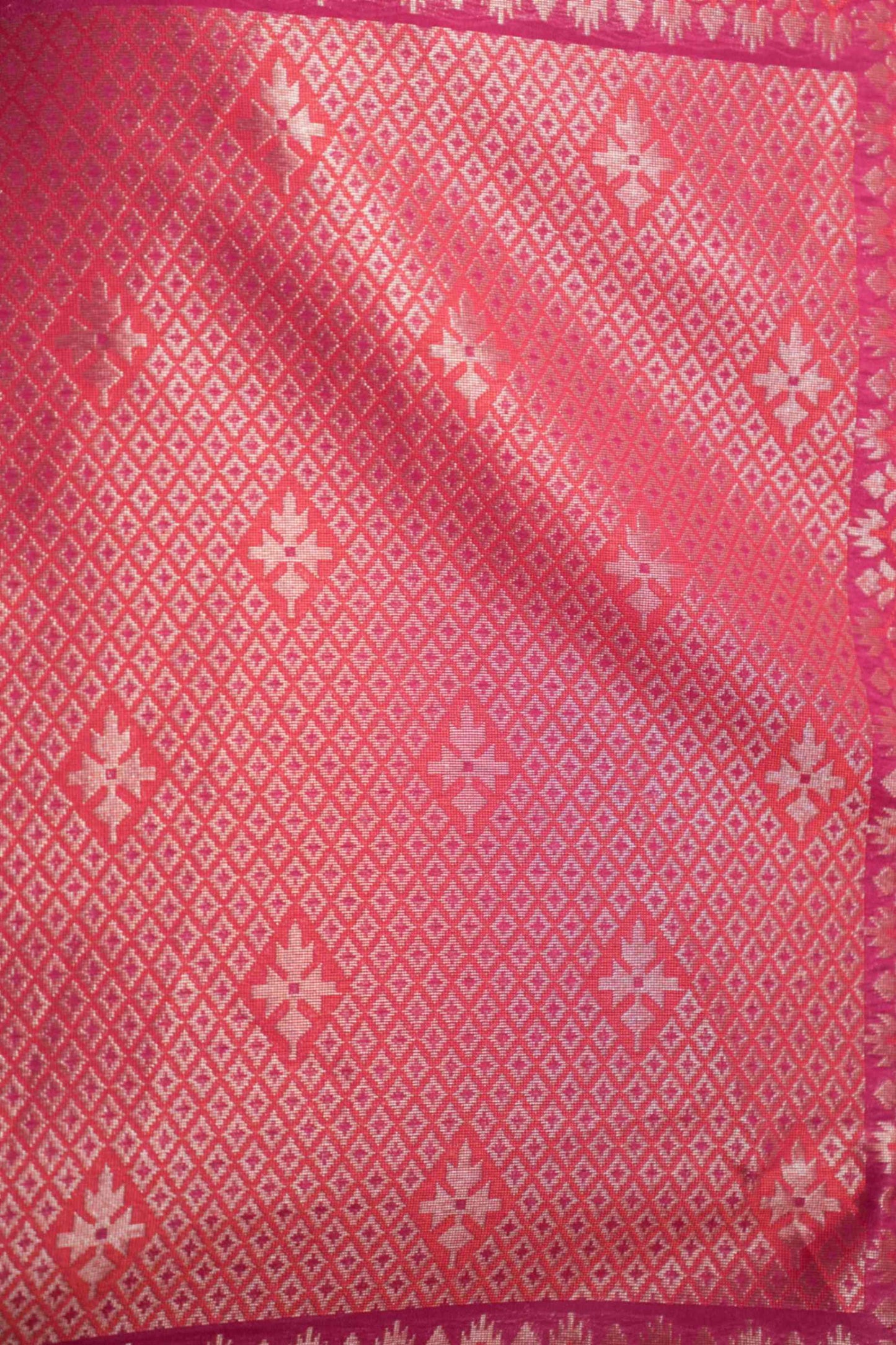 Close-up of zari detailing on Banarasi silk saree in pink georgette – featuring intricate jaal and gold weave.