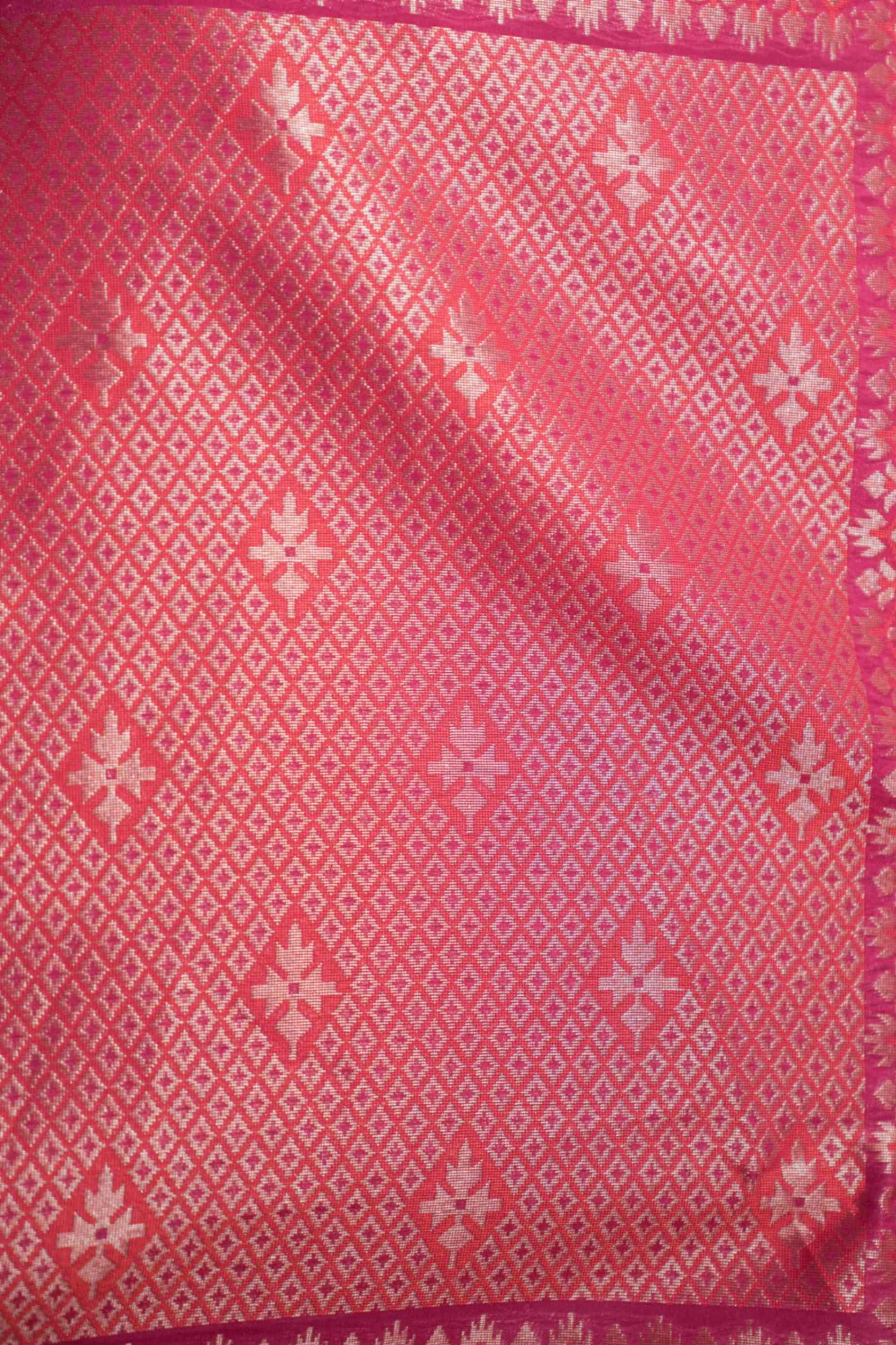 Close-up of zari detailing on Banarasi silk saree in pink georgette – featuring intricate jaal and gold weave.