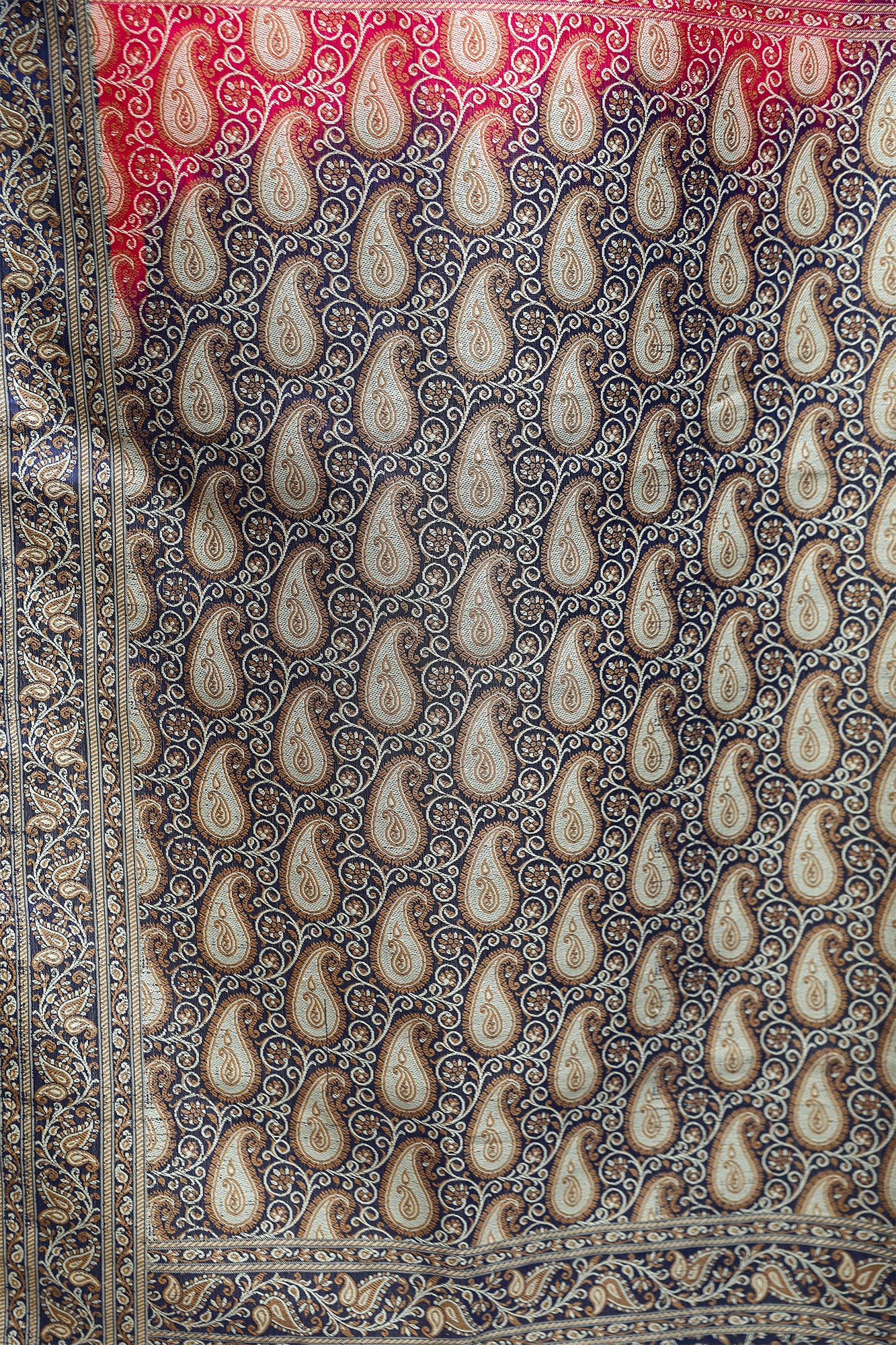 Close-up of intricate Tanchoi resham weave in Banarasi silk saree – pink body with contrasting blue blouse.
