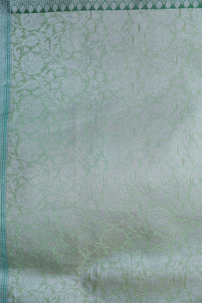 Close-up of silver zari jaal on exclusive Banarasi saree in Pashmina Kora Silk – elegant detailing for family occasions.